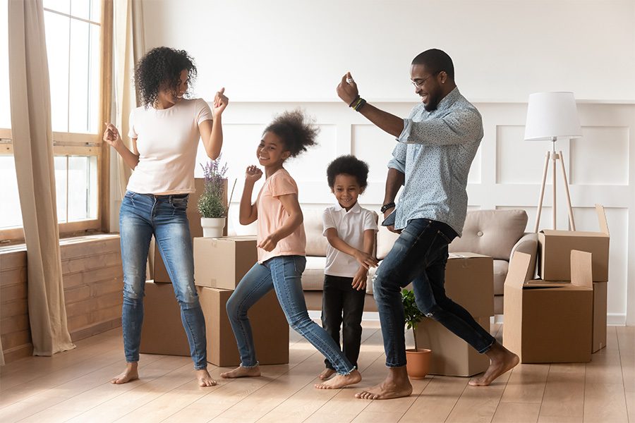 Personal Insurance - Family Dancing in Living Room of Their New House